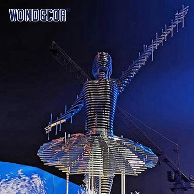 Large stainless steel character shaped outdoor sculpture in the park